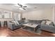 Inviting living room featuring a large sofa, hardwood floors and natural lighting at 22544 W Mohave St, Buckeye, AZ 85326