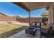 Covered outdoor patio featuring comfortable seating and a stylish fire pit at 22544 W Mohave St, Buckeye, AZ 85326