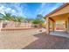 Backyard features gravel landscaping, desert trees, and covered patio at 2306 W Spur Dr, Phoenix, AZ 85085