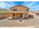 Exterior view of home with covered patio, gravel landscape, and fire pit area at 2306 W Spur Dr, Phoenix, AZ 85085