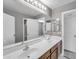 Bathroom with dual sinks, a large mirror, and plenty of storage at 2306 W Spur Dr, Phoenix, AZ 85085