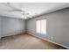 Comfortable bedroom with ceiling fan, neutral walls, and natural lighting at 2306 W Spur Dr, Phoenix, AZ 85085