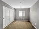 Neutral bedroom featuring a large closet and a window with blinds for natural light at 2306 W Spur Dr, Phoenix, AZ 85085