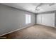 Bedroom with carpet, fan, window with blinds and a double door closet at 2306 W Spur Dr, Phoenix, AZ 85085