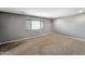 Bedroom features neutral paint, carpet flooring, and window with wood blinds at 2306 W Spur Dr, Phoenix, AZ 85085