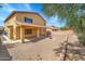 Exterior of home showcasing covered patio, gravel landscaping, and desert trees at 2306 W Spur Dr, Phoenix, AZ 85085