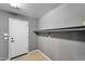 Laundry room showcasing a door and storage shelf at 2306 W Spur Dr, Phoenix, AZ 85085