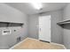 The laundry room features tile floors and convenient access to the exterior at 2306 W Spur Dr, Phoenix, AZ 85085