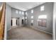 Large Living room showcasing tall windows, grey walls, high ceilings and carpet floors at 2306 W Spur Dr, Phoenix, AZ 85085