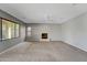 Open living room with fireplace, fan, and natural light from the many windows at 2306 W Spur Dr, Phoenix, AZ 85085