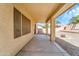 View of covered patio with gravel backyard and landscaping extending to a retaining wall at 2306 W Spur Dr, Phoenix, AZ 85085