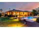 Outdoor backyard featuring a pool, covered patio, and manicured landscaping at 23213 N Del Monte Dr, Sun City West, AZ 85375