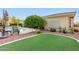 Relaxing backyard with a swimming pool, putting green, and outdoor seating at 23213 N Del Monte Dr, Sun City West, AZ 85375