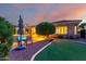 Beautiful backyard with swimming pool, covered patio, putting green, and seating area at 23213 N Del Monte Dr, Sun City West, AZ 85375