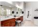 This bathroom features double sinks, wooden cabinets, and a bright vanity area at 23213 N Del Monte Dr, Sun City West, AZ 85375