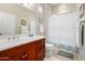 Bright bathroom features a cherry vanity with white countertop and framed mirror at 23213 N Del Monte Dr, Sun City West, AZ 85375