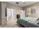 Cozy bedroom with an en-suite bathroom, featuring warm carpet and a window with plantation shutters at 23213 N Del Monte Dr, Sun City West, AZ 85375