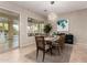 This dining room features neutral walls, contemporary lighting, and views of the outdoor pool at 23213 N Del Monte Dr, Sun City West, AZ 85375