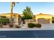 Inviting home featuring a meticulously manicured front yard and a covered two-car garage at 23213 N Del Monte Dr, Sun City West, AZ 85375