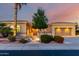 Beautiful home featuring an illuminated front yard, desert landscaping, and a gated front entrance at 23213 N Del Monte Dr, Sun City West, AZ 85375