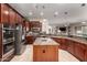 Kitchen with granite counters, a central island, pendant lights, and stainless steel appliances at 23213 N Del Monte Dr, Sun City West, AZ 85375