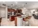 Open-concept kitchen features stainless steel appliances, granite countertops, a large island, and ample storage at 23213 N Del Monte Dr, Sun City West, AZ 85375