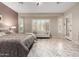 Large windows fill the main bedroom with natural light, highlighting the sitting area at 23213 N Del Monte Dr, Sun City West, AZ 85375