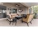 Covered patio features an outdoor seating area with a fire table and ceiling fan at 23213 N Del Monte Dr, Sun City West, AZ 85375