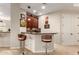 This wet bar offers a granite countertop, cabinetry for storage, lighting, and seating for casual entertaining at 23213 N Del Monte Dr, Sun City West, AZ 85375