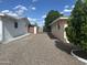 A low-maintenance backyard featuring gravel landscaping, a metal gate, and block fencing at 235 N 61St Pl, Mesa, AZ 85205