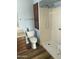 Bathroom features walk-in shower with seat, grab bars, and cabinet for storage at 235 N 61St Pl, Mesa, AZ 85205