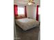 Cozy bedroom with large window, red curtains and neutral carpet at 235 N 61St Pl, Mesa, AZ 85205