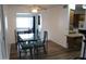 An open dining area with a glass-top table, leading to the kitchen, perfect for Gathering meals at 235 N 61St Pl, Mesa, AZ 85205