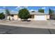 Well-maintained home featuring lovely landscaping, mature tree, and a two-car garage at 235 N 61St Pl, Mesa, AZ 85205