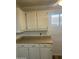 Traditional style kitchen cabinets and countertops offering ample storage in a functional space at 235 N 61St Pl, Mesa, AZ 85205