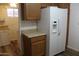 The kitchen space has wooden cabinetry and features a large, white refrigerator at 235 N 61St Pl, Mesa, AZ 85205