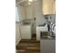 Functional laundry area with white washer, dryer, cabinets, and sink in a well-lit, clean space at 235 N 61St Pl, Mesa, AZ 85205