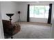 Inviting living room featuring a comfortable recliner and a large window with ample natural light at 235 N 61St Pl, Mesa, AZ 85205