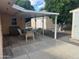 Covered patio featuring a dining set, perfect for outdoor entertaining and enjoying the serene backyard at 235 N 61St Pl, Mesa, AZ 85205