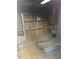 Bare interior of a storage shed or workshop, featuring open shelving, wood flooring and walls at 235 N 61St Pl, Mesa, AZ 85205
