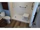 Roll-in shower with shower chair and grab bars at 235 N 61St Pl, Mesa, AZ 85205