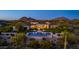 Stunning aerial view of desert home, showcasing a backyard pool, a cozy firepit, and mountain views at 24066 N 90Th Way, Scottsdale, AZ 85255