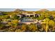 Breathtaking aerial view of a luxury home with a pool, fire pit, and desert landscape, showcasing its grandeur and beauty at 24066 N 90Th Way, Scottsdale, AZ 85255