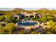 Luxury home with a backyard pool, lounge chairs, and beautiful desert landscaping and mountain views at 24066 N 90Th Way, Scottsdale, AZ 85255
