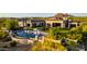 An aerial view of a luxury home with a pristine pool and desert landscaping in an upscale community at 24066 N 90Th Way, Scottsdale, AZ 85255