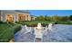 Beautiful backyard featuring a fire pit with Adirondack chairs and landscaped hedges at 24066 N 90Th Way, Scottsdale, AZ 85255