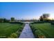 Beautiful backyard with manicured landscaping, stone pathway, fire pit, and lounge area for outdoor entertaining at 24066 N 90Th Way, Scottsdale, AZ 85255