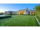 Expansive backyard featuring lush green lawn, manicured hedges, and modern architecture at 24066 N 90Th Way, Scottsdale, AZ 85255
