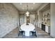 Dining room features modern decor, a large table with seating for ten, and brick accent wall at 24066 N 90Th Way, Scottsdale, AZ 85255