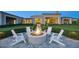 Cozy outdoor fire pit surrounded by comfortable seating, set against the backdrop of the home's elegant architecture at 24066 N 90Th Way, Scottsdale, AZ 85255